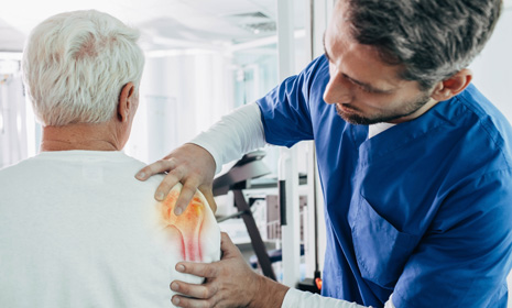 Healthcare professional examining patient’s shoulder